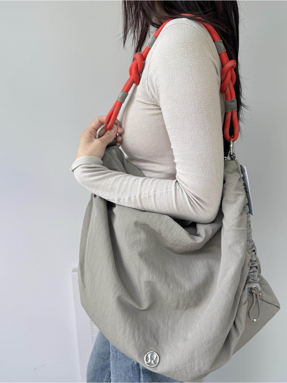 ISO lululemon athletica Slouchy Shoulder Hobo Bag in Light Gray with Coral Strap
